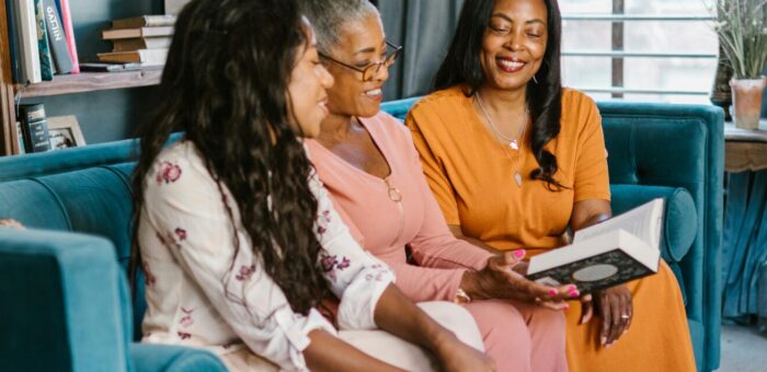three women sitting on a couch before checking in with our cosmetic dentist houston